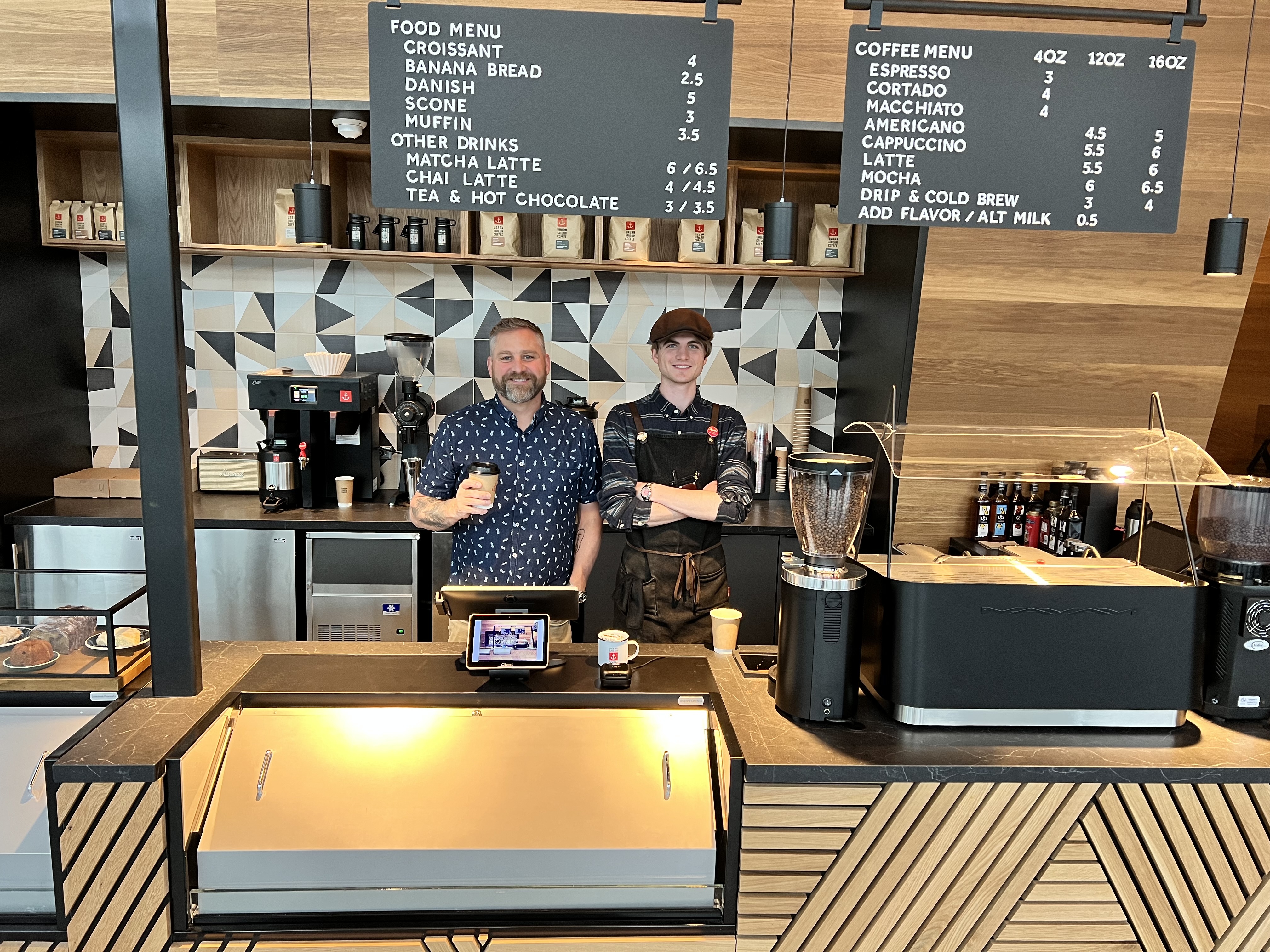 Co-owners and father-son duo Tyler and Archer Anderson stand inside the Urban Sailor coffee shop