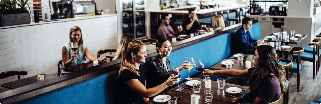 Restaurant party enjoying glasses of wine before their meal