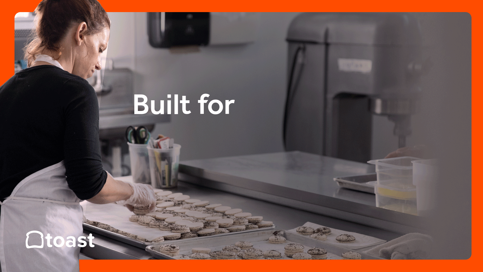 A still image of a woman assembling pastries in a kitchen. The bottom left corner has a white Toast logo. There is an animated overlay that reads, "Built for less time filing out paperwork. Built for more time fulfilling allllll those orders. Now introducing Toast Invoicing."