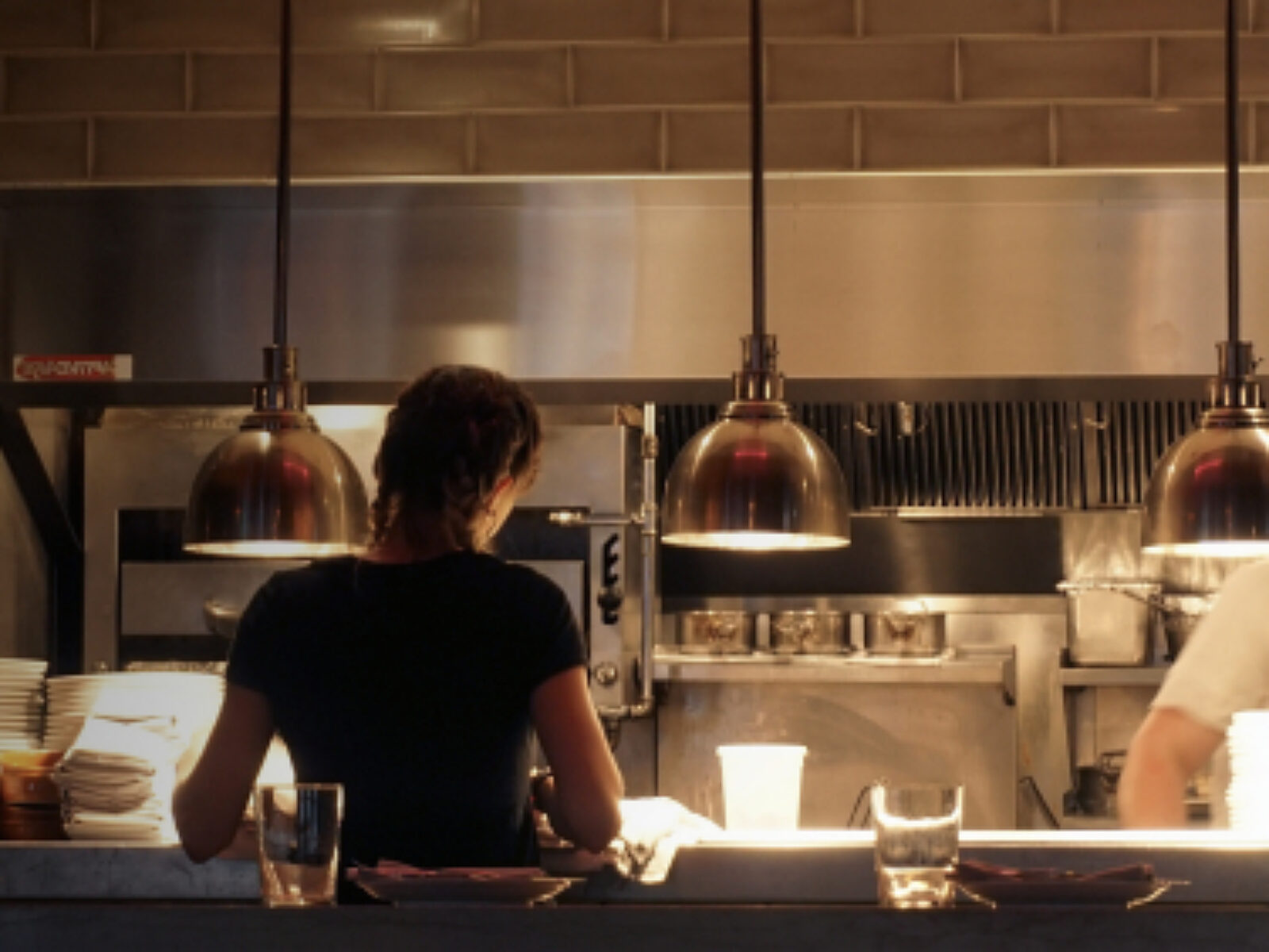 waiter waiting for food at kitchen counter