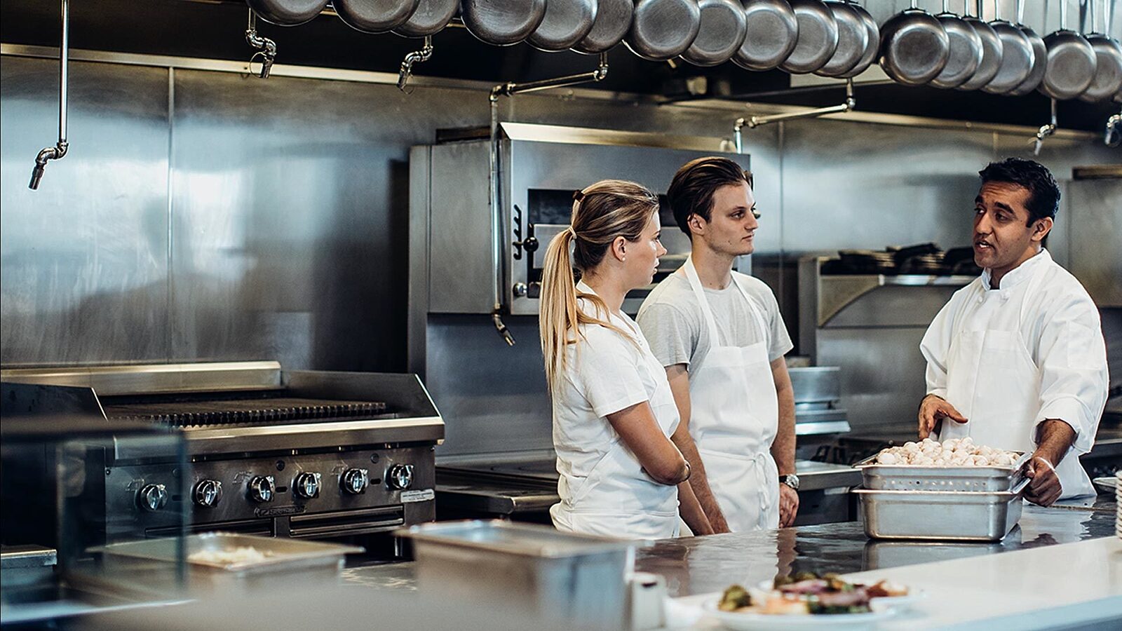 Millennials learning from a chef.