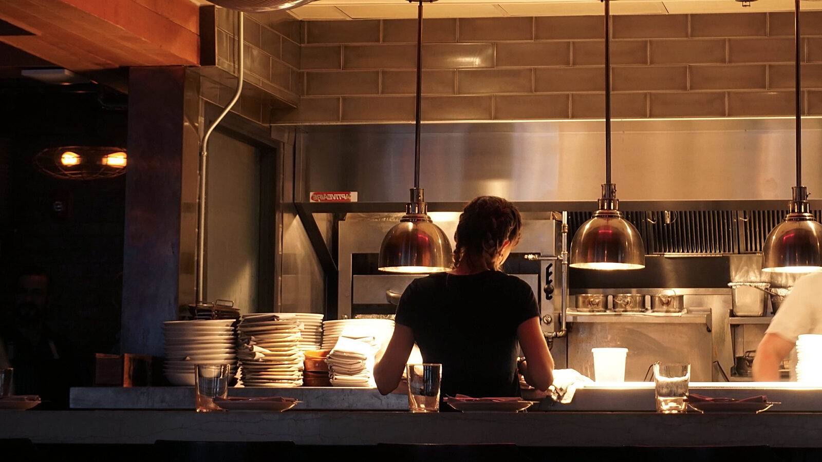 waiter waiting for food at kitchen counter